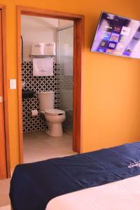 a bathroom with a toilet and a shower in a room at HOTEL CHURUMUCO in San José Iturbide