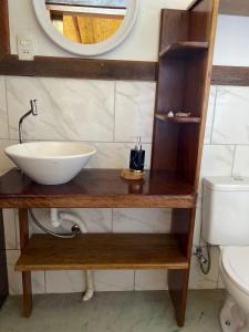 a bathroom with a sink and a mirror at Chalé Filhos da Terra in São Francisco Xavier +14 photos