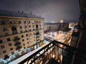 a view of a city at night from a balcony at Kyiv Gallery Apartment in Kyiv