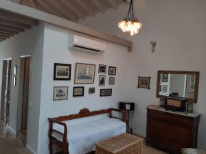 a bedroom with a bed and a dresser and a mirror at En Patmo Holiday Home in Patmos