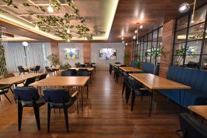a dining room with wooden tables and chairs at Hotel La Villa in Gjakove