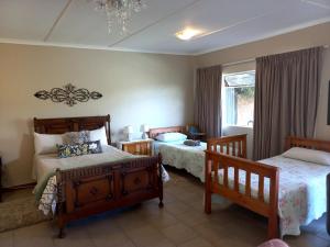 a bedroom with two beds and a window at Starry Nights in Middelburg