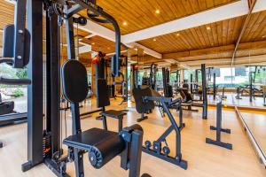 a gym with treadmills and elliptical machines at Pousada Natribus Rosa in Praia do Rosa