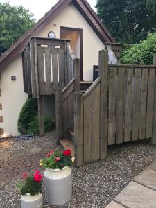 a house with a fence and flowers in front of it at The Firs - Englefied studio in Douglas