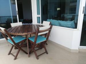 a wooden table and chairs sitting on a balcony at Terraza Morros in Cartagena de Indias