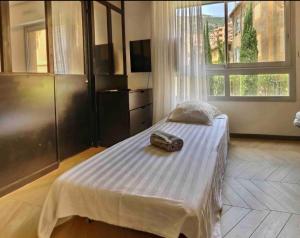 a bedroom with a bed with a camera on it at Beautiful Fully Renovated Centrally Located Studio in Monte Carlo