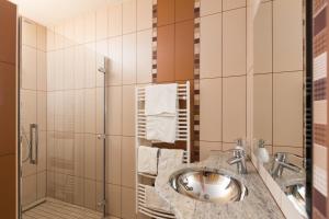 a bathroom with a sink and a shower at Natura Amon in Podčetrtek +73 photos