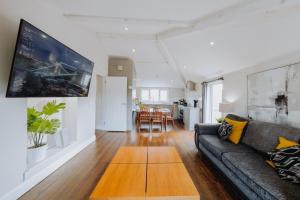 a living room with a couch and a table at Smart-Home in Original Victorian Building in Bristol