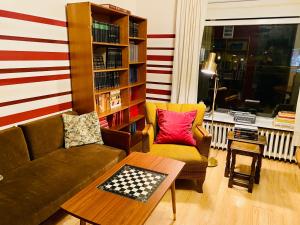 a living room with a couch and a book shelf at The Bookstore Family Apartment in Hellissandur