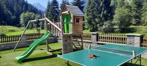 a playground with a slide and a swing set at Landhaus Volderau in Neustift im Stubaital