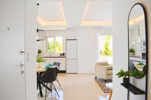 a kitchen and living room with a table and chairs at New Build Apartment on Beautiful Modern Complex in Rojales