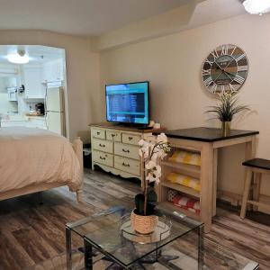 a bedroom with a bed and a tv and a table at Stay ON the beach! Wonderful location! in Daytona Beach