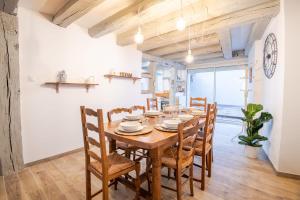 a dining room with a wooden table and chairs at La Maison Lamartine Havre de paix dans le centre de Tours in Tours +16 photos