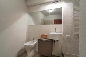 a bathroom with a sink and a toilet and a mirror at A dream in Portofino Piazzetta in Portofino