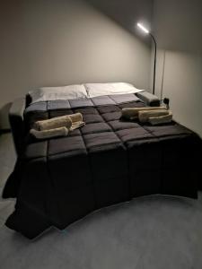 A bed or beds in a room at AGAS Exclusive Apartment
