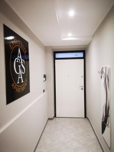 a room with a door and a sign on the wall at AGAS Exclusive Apartment in Catanzaro