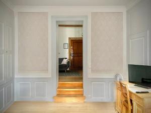 a hallway with a door leading to a living room at Beautiful studio in a villa from 18th century in Thun