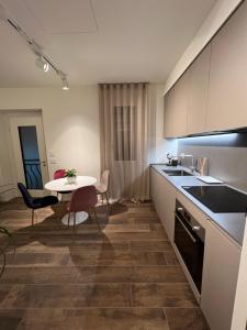 a kitchen with a table and a small table with chairs at DR54 Apartments in Rho