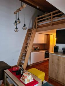 a living room with a loft bed and a kitchen at Aparthotel Vučko Apartment Farra in Jahorina