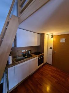 a small kitchen with a sink and a stove at Aparthotel Vučko Apartment Farra in Jahorina