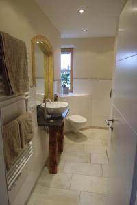 a bathroom with a sink and a toilet at Ferienwohnung mit wundervollen Bergblick in Lenggries