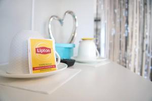 a shelf with a cup of lipton coffee on a table at Spacious Guest Suite Amazing Location in San Diego