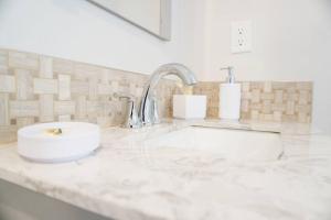 a white counter top with a sink in a bathroom at Spacious Guest Suite Amazing Location in San Diego +25 photos