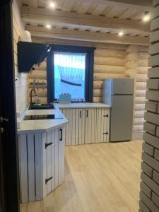 a kitchen with a sink and a refrigerator at Magura Resort in Yablunytsya