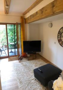 a living room with a flat screen tv on the wall at Top Apartment 3 in Rosengarten/Hamburg in Rosengarten