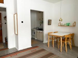 a kitchen and dining room with a table and chairs at Aalto Apartments Sunila Honkala 1 in Kotka