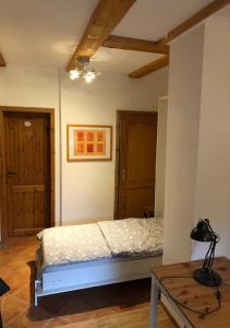 a bedroom with a bed and a wooden table at Top Apartment 3 in Rosengarten/Hamburg in Rosengarten