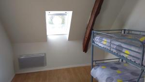 a bunk bed in a room with a window at Jolie maison proche Mont St michel et Saint Malo in Le Vivier-sur-Mer