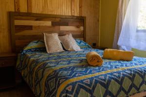 Postel nebo postele na pokoji v ubytování Cabañas Aliwen Panguipulli