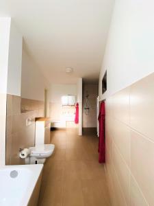 ein Badezimmer mit Toilette und Waschbecken in der Unterkunft Fewo unweit Warnemünde Sobierajczyk in Markgrafenheide in Rostock + 37 Fotos