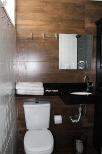 a bathroom with a toilet and a sink at Hotel Flor Paulista in São Paulo +66 photos
