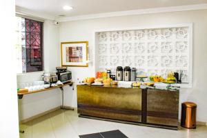 a kitchen with a counter with food on it at Hotel Flor Paulista in São Paulo