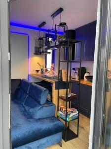 a living room with a blue couch and a kitchen at Gler house in Białka Tatrzanska +17 photos
