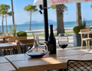 a table with a bottle of wine and a glass at ELMAR HOTEL in Vlorë