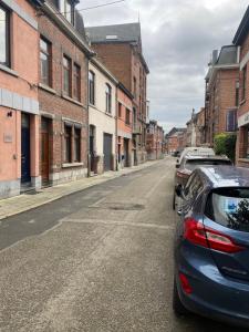 een straat met auto's aan de kant van de weg bij À deux PATENIER de Dinant in Dinant