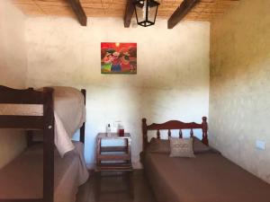 a room with two beds and a picture on the wall at Matices de Molinos Hostal in Molinos