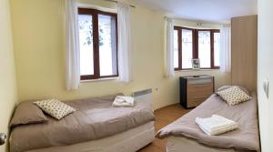A bed or beds in a room at Ski Area 202 apt, The Castle 1, Pamporovo