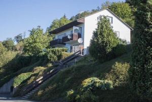 a house on the side of a hill at Ferienwohnung Hillebachsee in Winterberg