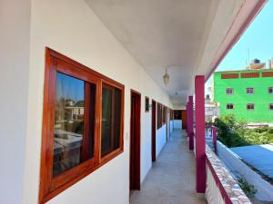 a row of windows on the side of a building at Posada Casa Bugambilias in Tecolutla