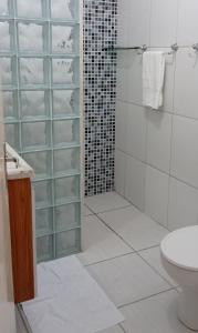 a bathroom with a glass shower and a toilet at Apto Olinda Casa Caiada ao lado do Shopping in Olinda