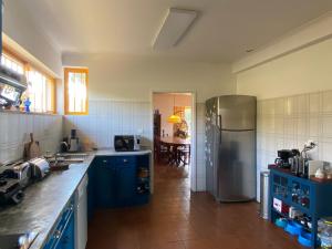 a kitchen with blue cabinets and a stainless steel refrigerator at Casa de Pereiras, Vimioso in Vimioso