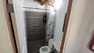 a small bathroom with a toilet and a shower at Casa La Martina disponible en Jardín Antioquia in Jardin