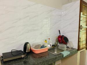 a kitchen counter top with a sink and a counter top at Sweet Home in Phnom Penh