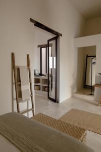 a room with a bed and a mirror at Narrativ Lofts -Solario- Charming Historic Escape in Campeche