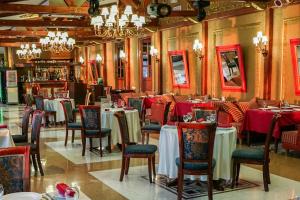 a restaurant with tables and chairs in a room at Legend of Baikal in Listvyanka