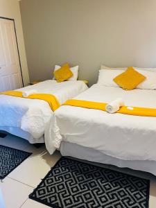 two beds sitting next to each other in a room at ONNIE GUESTHOUSE in Louis Trichardt